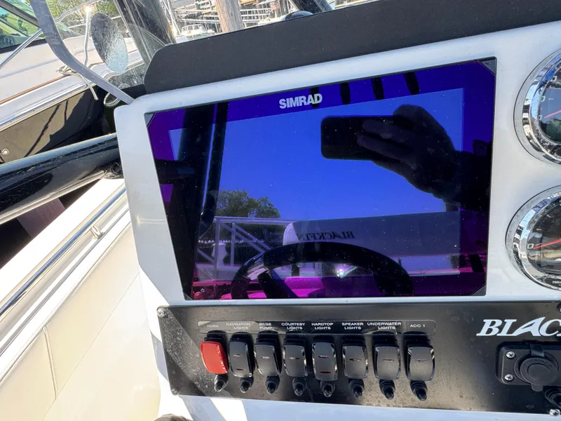 Slide: The Image of Control panel of a 2020 Blackfin 212 CC boat with Simrad display. - 17