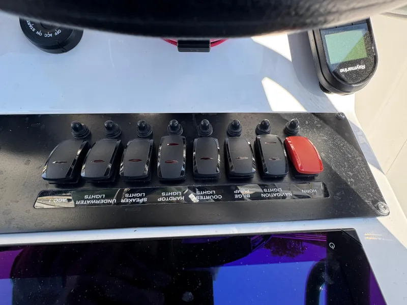 Slide: The Image of Control panel of a 2020 Blackfin 212 CC boat with labeled switches. - 22