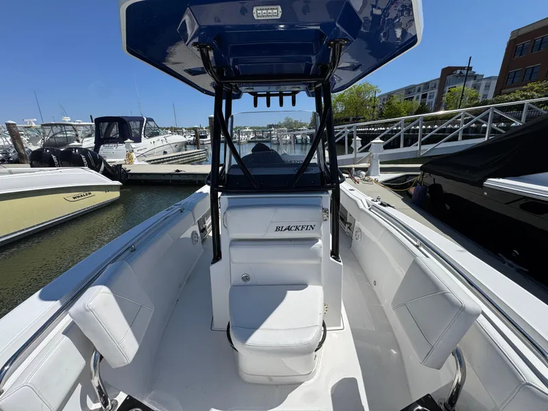 Slide: The Image of 2020 Blackfin 212 CC boat docked at marina, featuring sleek design and spacious seating. - 30