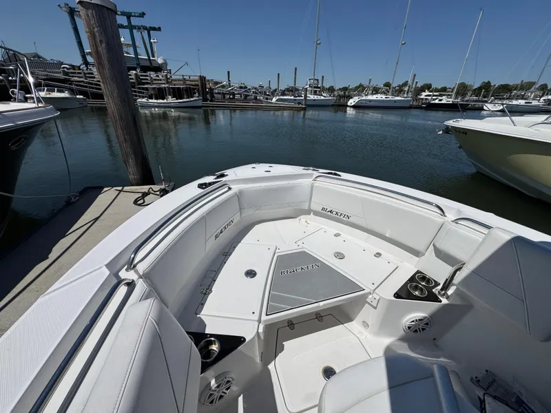 Slide: The Image of 2020 Blackfin 212 CC boat interior with seating, docked at marina. - 34