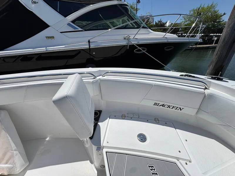 Slide: The Image of 2020 Blackfin 212 CC boat interior with sleek white seating and storage compartments. - 35