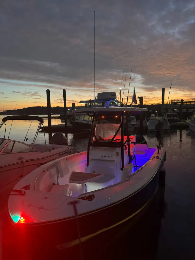 Slide: The Image of 2020 Blackfin 212 CC boat docked at sunset with colorful lights. - 39
