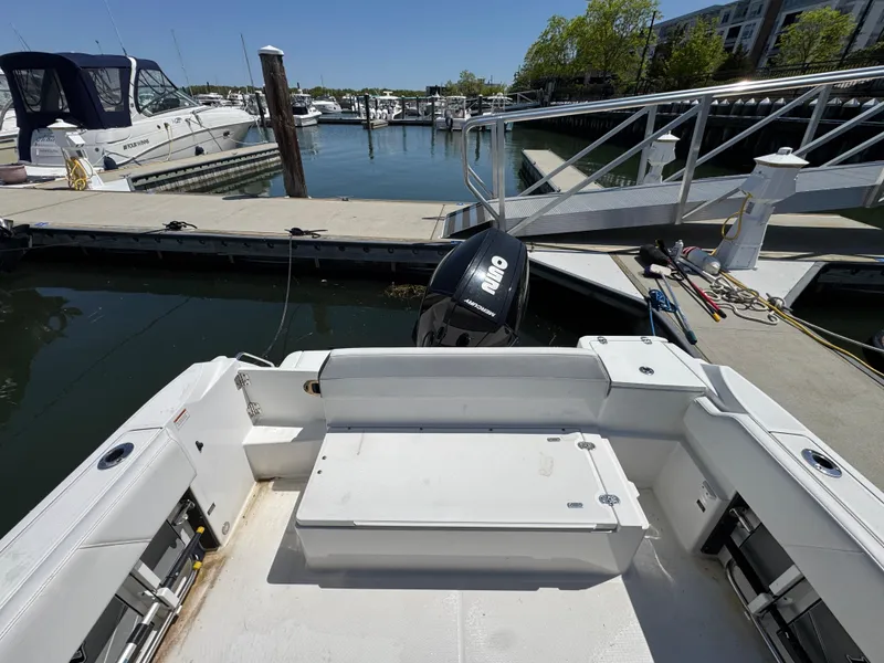 Slide: The Image of 2020 Blackfin 212 CC boat docked at marina with outboard motor. - 6