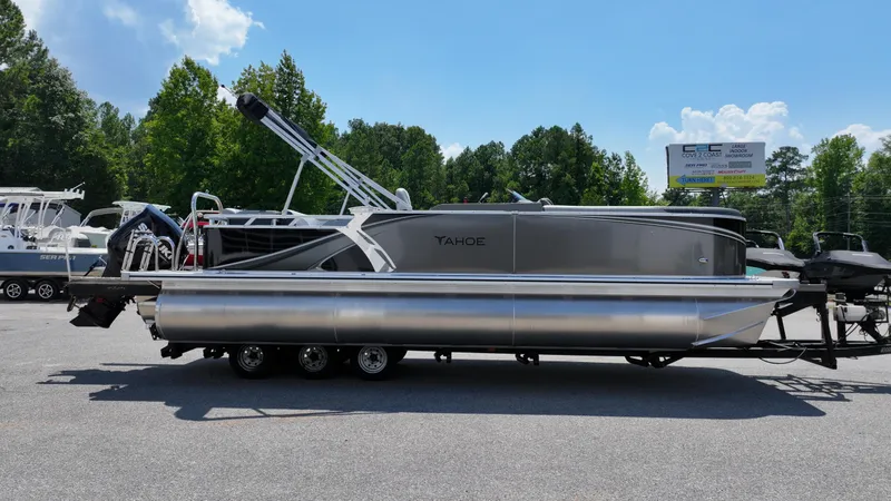 Slide: The Image of 2025 Tahoe Pontoon LTZ Cruise boat on trailer, parked outdoors under clear sky. - 3