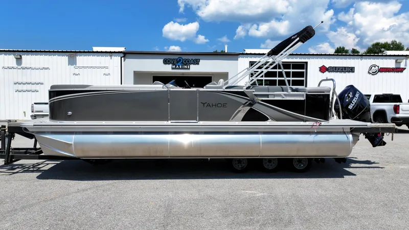 Slide: The Image of 2025 Tahoe Pontoon LTZ Cruise boat parked at Cove 2 Coast Marine dealership. - 6