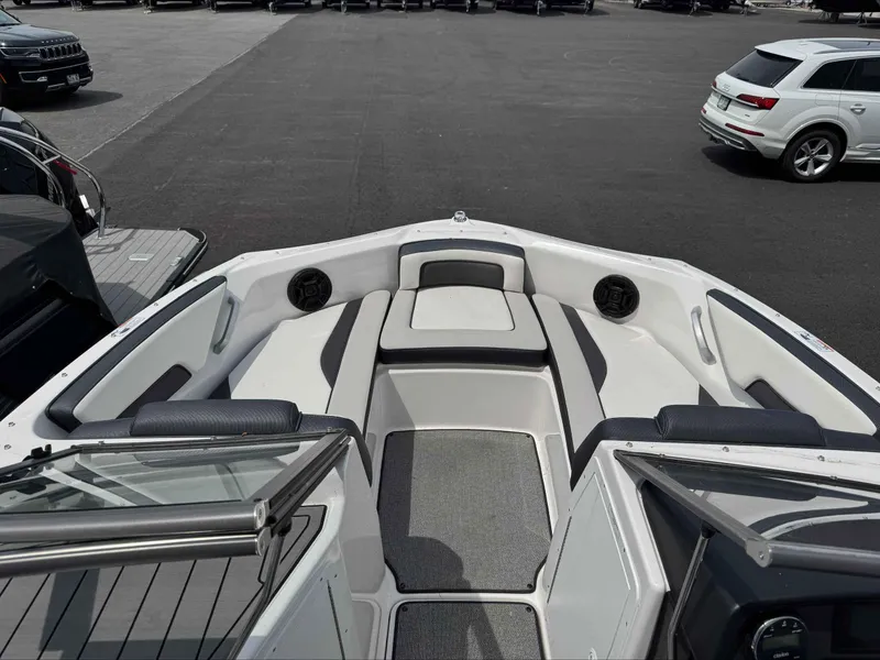 Slide: The Image of 2019 Yamaha Boats AR195 interior with seating and speakers, parked in a lot. - 10