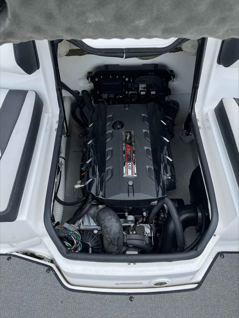Slide: The Image of 2019 Yamaha AR195 boat engine compartment, showcasing a powerful, well-maintained engine. - 6