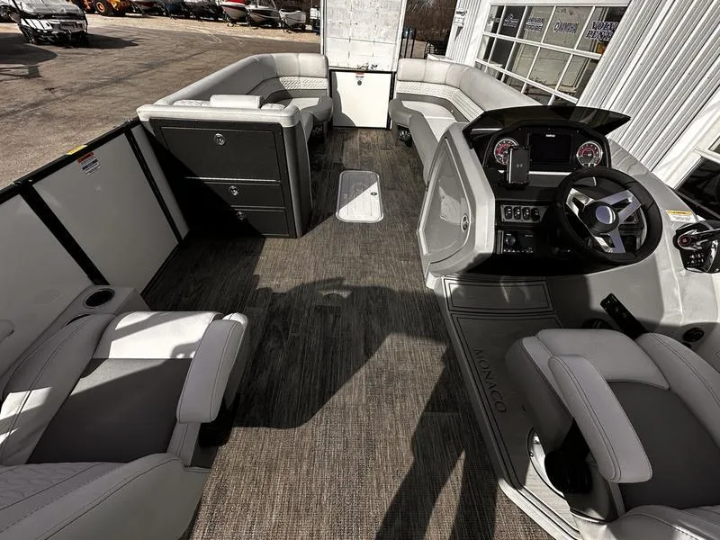 Slide: The Image of Luxurious 2025 Godfrey Monaco 255 DFL pontoon boat interior with modern seating and helm. - 12