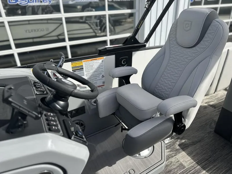 Slide: The Image of Captain's seat of 2025 Godfrey Monaco 255 DFL iMPACT pontoon boat, featuring modern controls. - 8