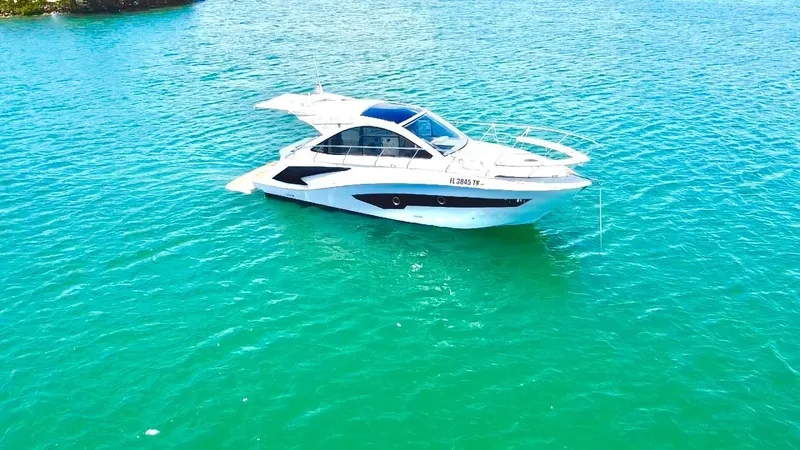 Slide: The Image of Evolve 400HT 2022 yacht on turquoise water, showcasing sleek design and luxury. - 1