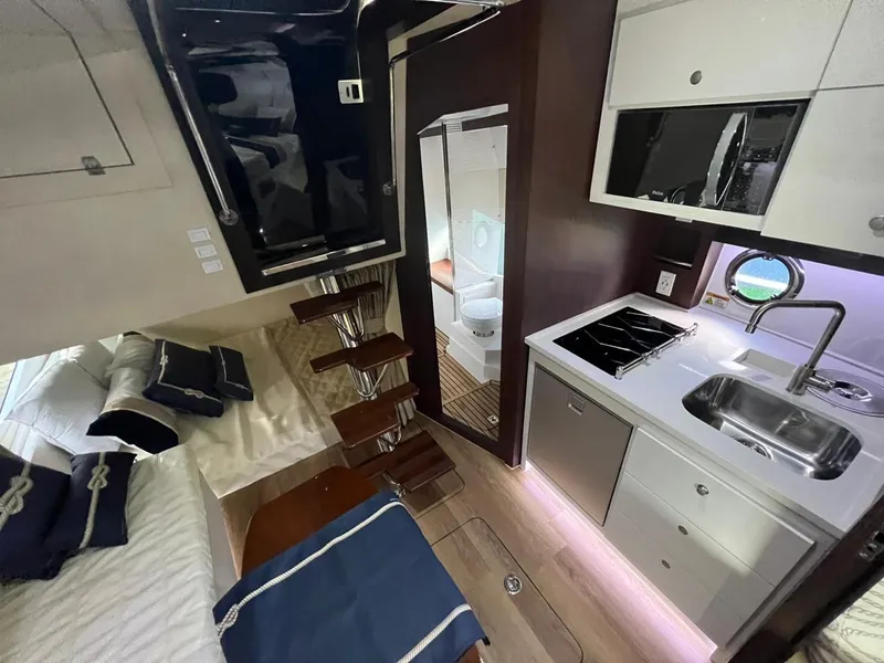 Slide: The Image of Interior of 2022 Evolve 400HT yacht with modern kitchen, bed, and stairs. - 11