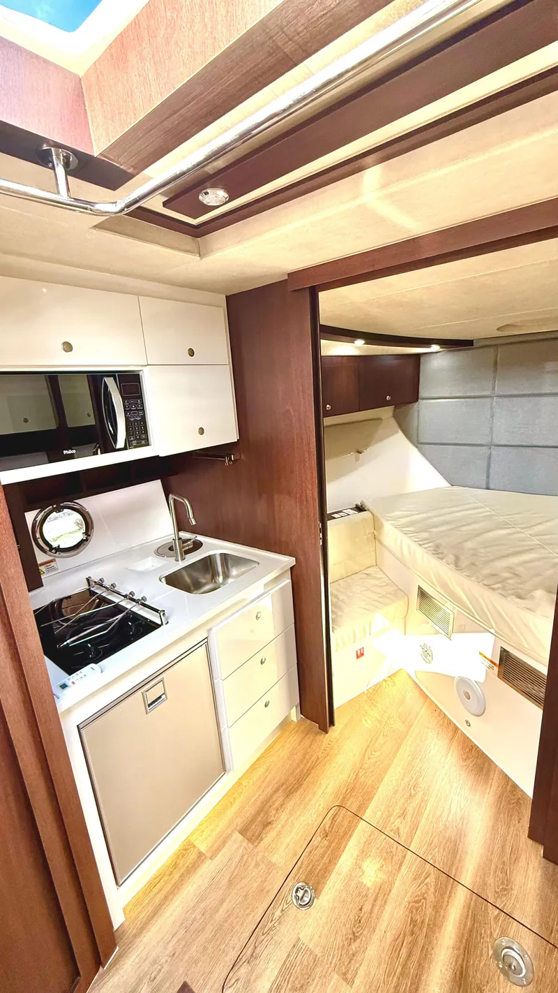 Slide: The Image of 2022 Evolve 400HT yacht interior with kitchenette and cozy sleeping area. - 15