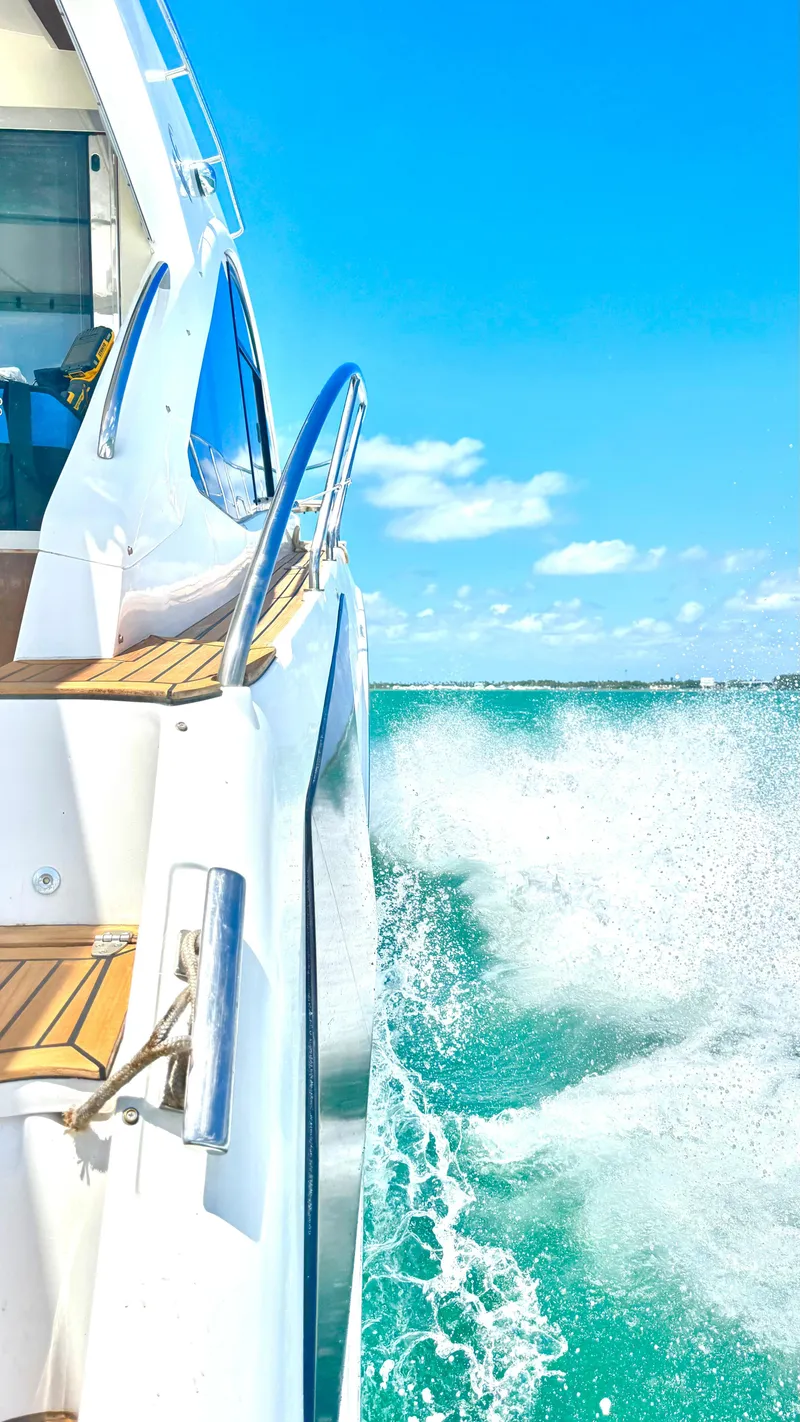 Slide: The Image of Evolve 400HT yacht cruising on turquoise waters under a clear blue sky, 2022 model. - 20
