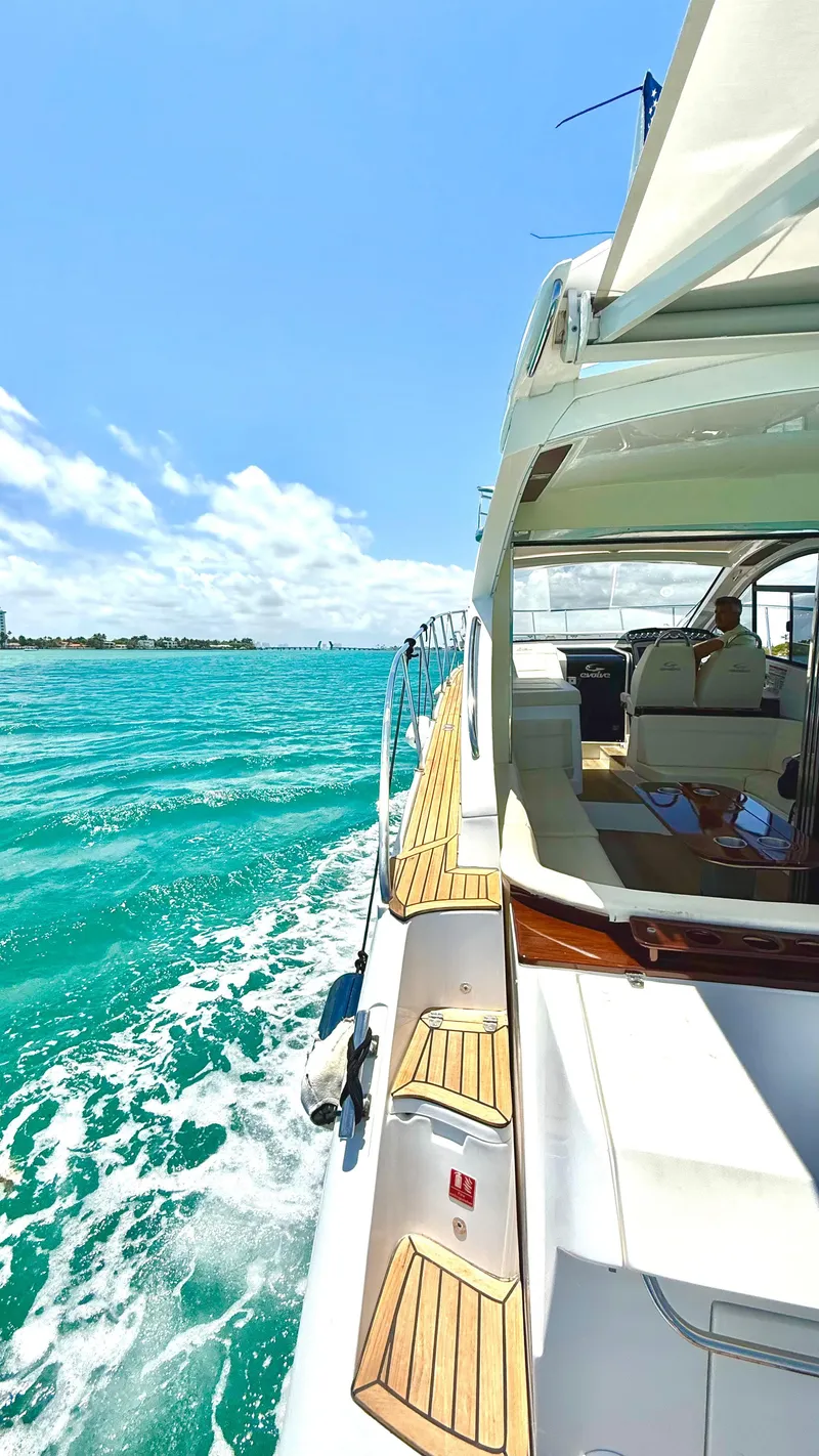 Slide: The Image of Luxury Evolve 400HT yacht cruising on turquoise waters under a clear blue sky. - 21