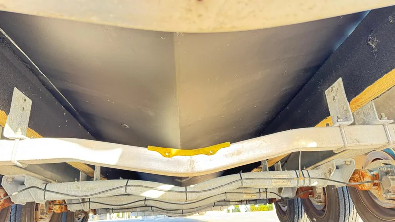 Slide: The Image of Underside view of 2022 Evolve 400HT boat on trailer, showcasing hull and suspension. - 28