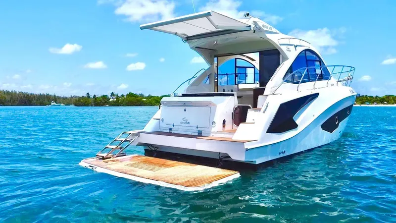 Slide: The Image of Luxury 2022 Evolve 400HT yacht on serene blue waters, featuring a spacious deck. - 3