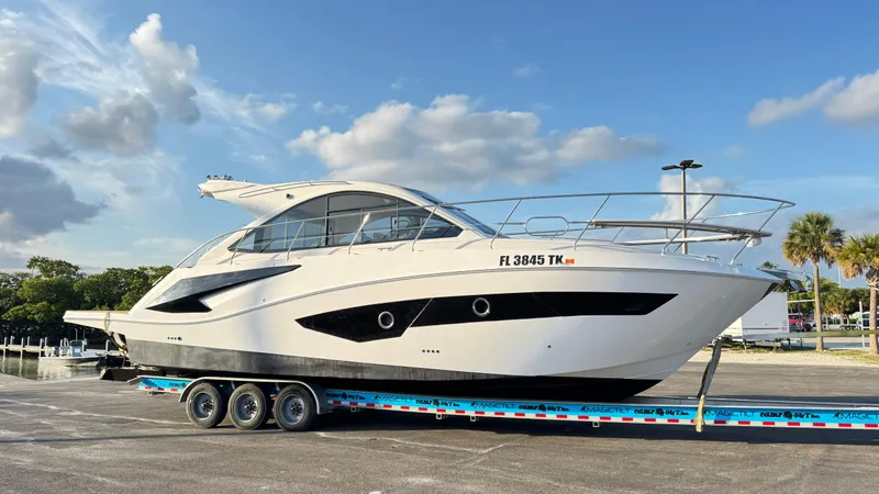 Slide: The Image of 2022 Evolve 400HT yacht on trailer under blue sky. - 31