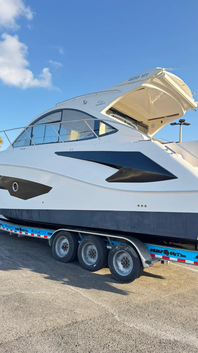 Slide: The Image of Evolve 400HT 2022 yacht on trailer under clear blue sky. - 33