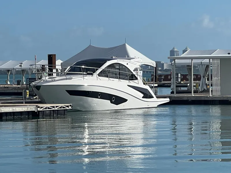Slide: The Image of Luxury Evolve 400HT yacht docked at marina, 2022 model, calm waters, clear sky. - 4