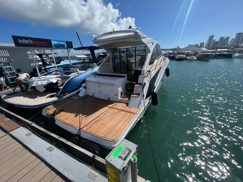 Slide: The Image of Evolve 400HT 2022 yacht docked at marina under clear blue sky. - 6