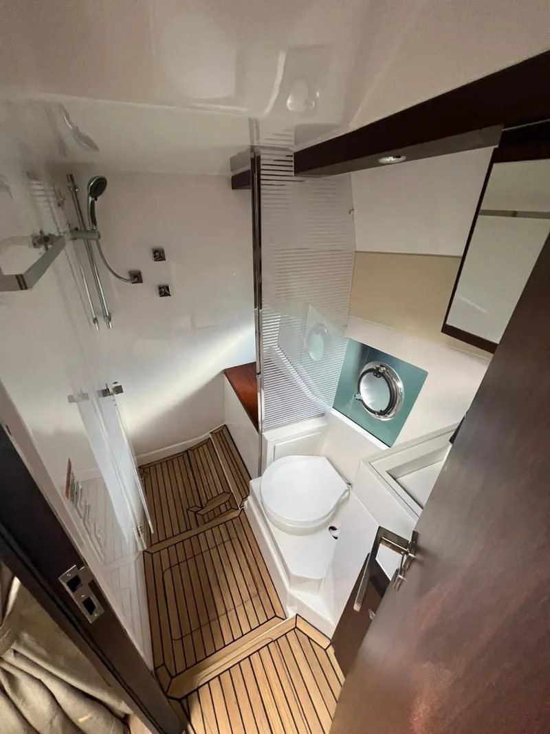 Slide: The Image of Modern bathroom in 2022 Evolve 400HT yacht with wood flooring and sleek fixtures. - 7