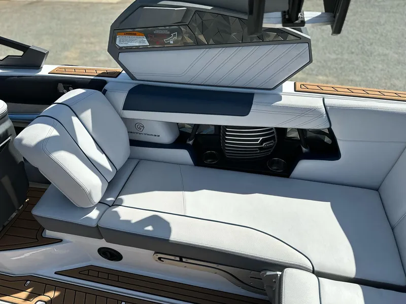 Slide: The Image of 2019 Nautique Super Air G23 interior with white seating and modern dashboard design. - 11