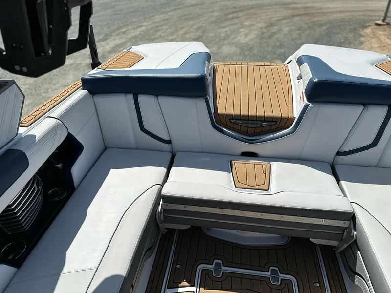 Slide: The Image of 2019 Nautique Super Air G23 boat interior with cushioned seating and teak flooring. - 12