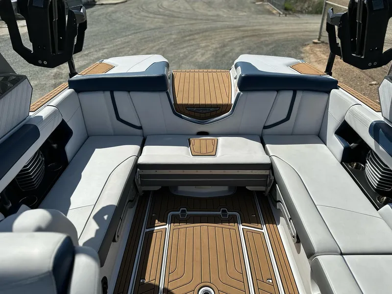 Slide: The Image of 2019 Nautique Super Air G23 boat interior with luxurious seating and teak flooring. - 13