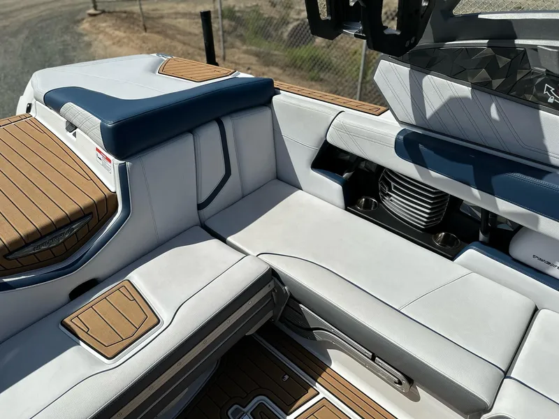 Slide: The Image of 2019 Nautique Super Air G23 boat interior with luxurious seating and teak accents. - 15