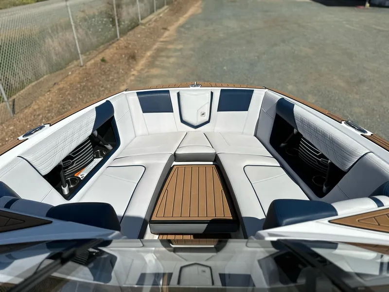 Slide: The Image of 2019 Nautique Super Air G23 boat interior with luxurious seating and teak flooring. - 20