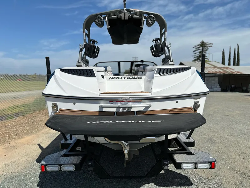Slide: The Image of 2019 Nautique Super Air G23 boat, rear view, parked on a sunny day. - 5