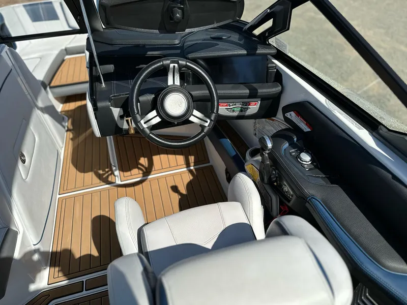 Slide: The Image of 2019 Nautique Super Air G23 boat interior with sleek dashboard and modern steering wheel. - 7