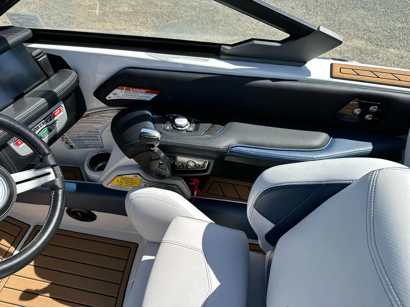Slide: The Image of 2019 Nautique Super Air G23 boat interior with steering wheel and control panel. - 9