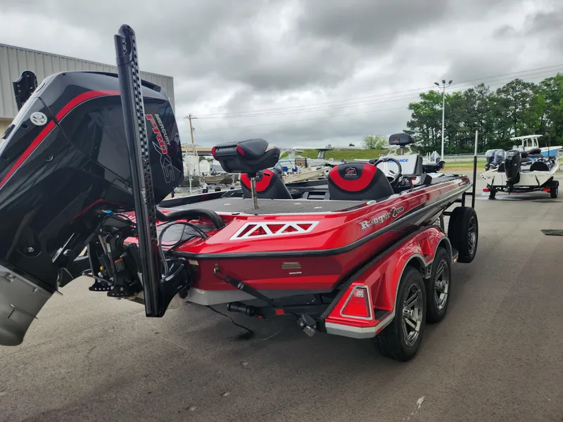 Slide: The Image of 2022 Ranger Z521L RANGER CUP EQUIPPED boat, red, parked outdoors on a cloudy day. - 5