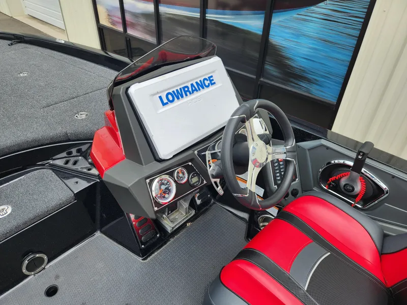 Slide: The Image of 2022 Ranger Z521L boat dashboard with Lowrance display and red-black seating. - 6