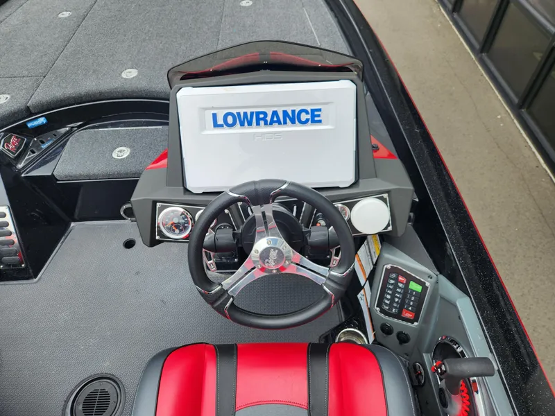 Slide: The Image of 2022 Ranger Z521L boat dashboard with Lowrance display and red-black seating. - 7