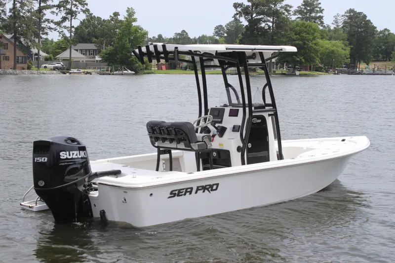 Slide: The Image of 2025 Sea Pro 210 boat with Suzuki engine on a calm lake. - 1