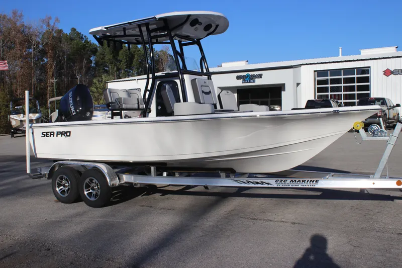 Slide: The Image of 2025 Sea Pro 210 boat on trailer, parked outdoors near a building. - 10
