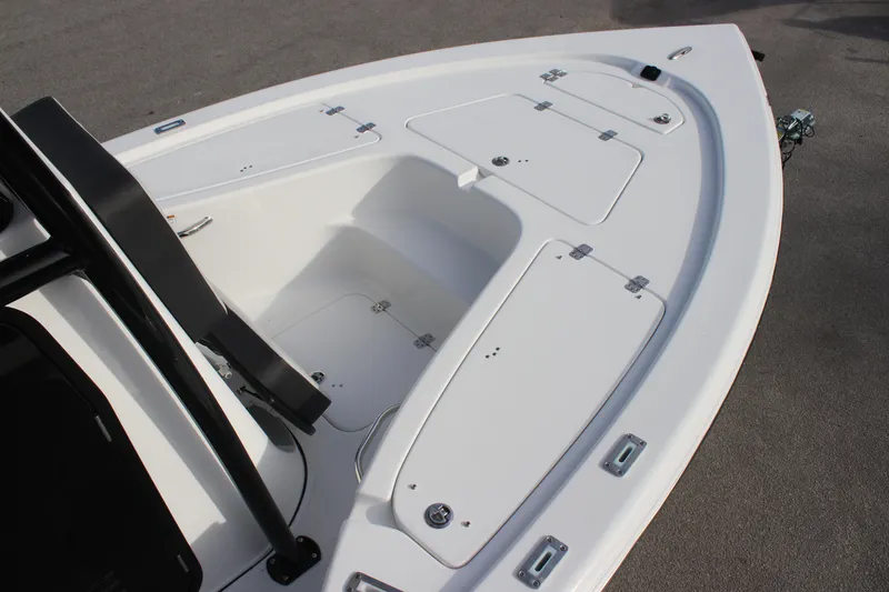 Slide: The Image of 2025 Sea Pro 210 boat deck with storage compartments and sleek design. - 13