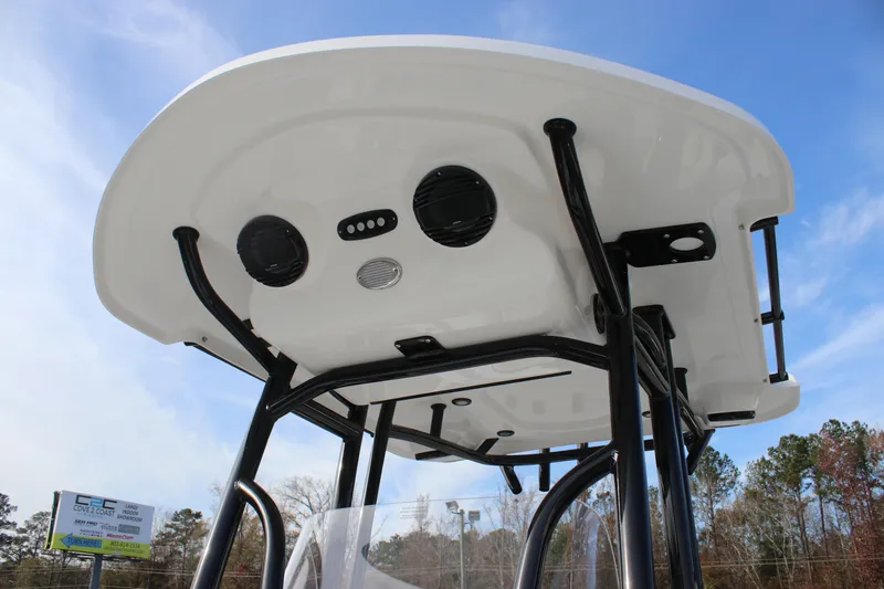 Slide: The Image of 2025 Sea Pro 210 boat T-top with speakers and lights against a clear sky. - 16