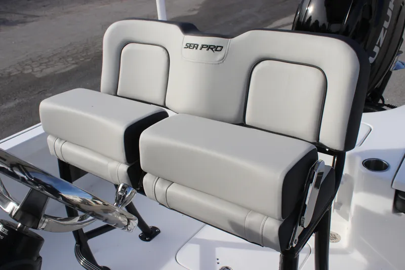 Slide: The Image of 2025 Sea Pro 210 boat seating with dual cushioned seats and steering wheel. - 17