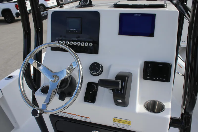 Slide: The Image of 2025 Sea Pro 210 boat dashboard with steering wheel, controls, and electronic displays. - 18