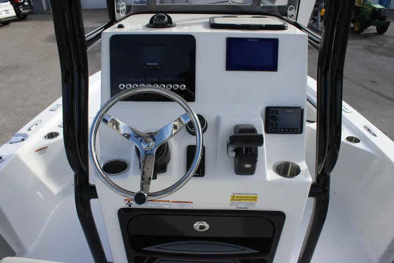 Slide: The Image of 2025 Sea Pro 210 boat console with steering wheel and navigation controls. - 19
