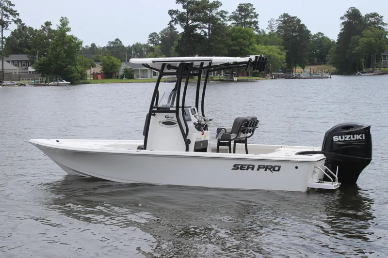 Slide: The Image of 2025 Sea Pro 210 boat with Suzuki engine on a calm lake. - 2