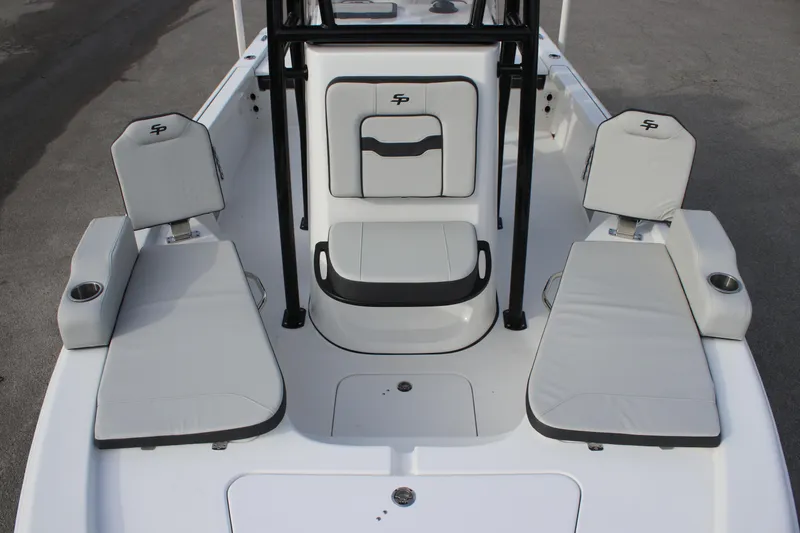 Slide: The Image of 2025 Sea Pro 210 boat interior with cushioned seating and storage compartments. - 26