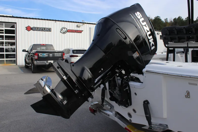 Slide: The Image of 2025 Sea Pro 210 boat with Suzuki outboard motor at dealership. - 28