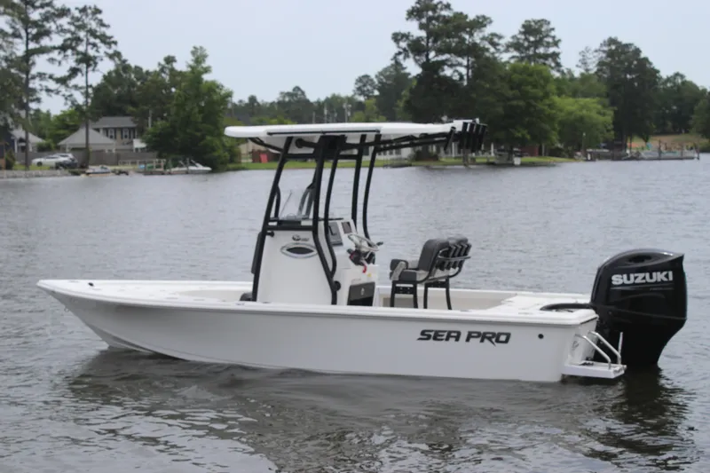 Slide: The Image of 2025 Sea Pro 210 boat with Suzuki engine on a calm lake. - 4