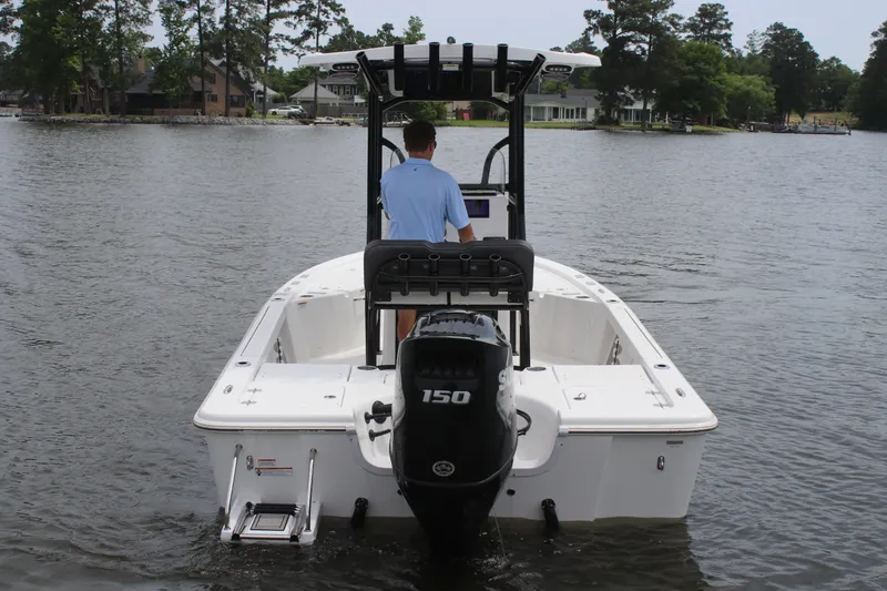 Slide: The Image of 2025 Sea Pro 210 boat on a lake, rear view with outboard motor. - 5