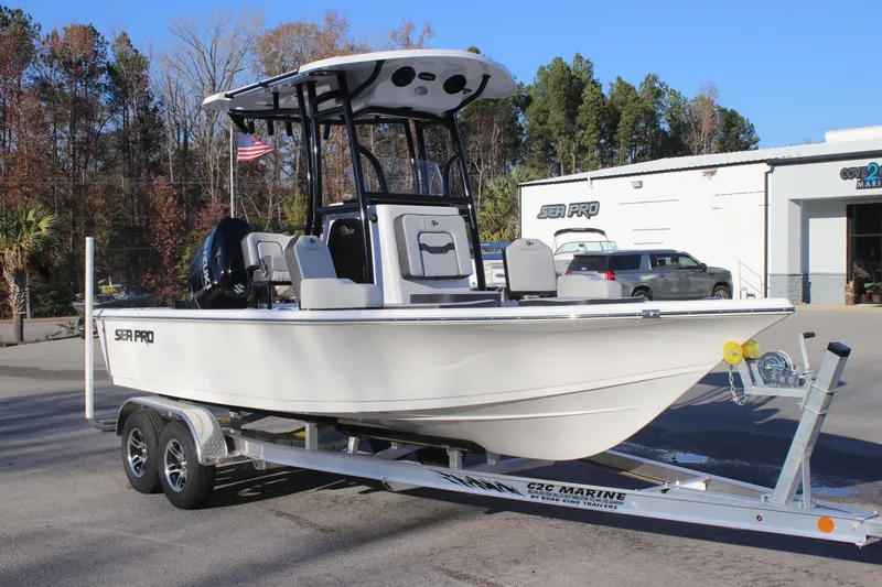 Slide: The Image of 2025 Sea Pro 210 boat on trailer, parked outdoors near dealership. - 7
