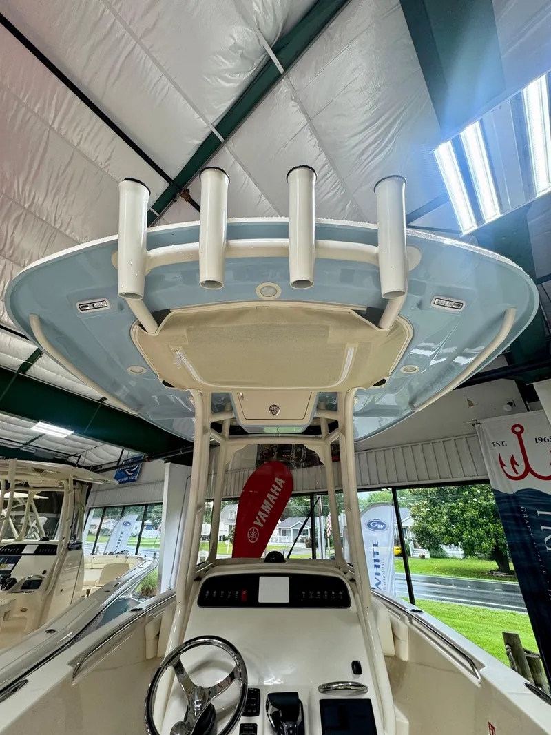 Slide: The Image of 2025 Grady-White Fisherman 236 boat interior with rod holders and steering console. - 4